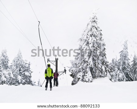 Winter tree boron / mountain Kopaonik Serbia / Old ski lift and two ski man