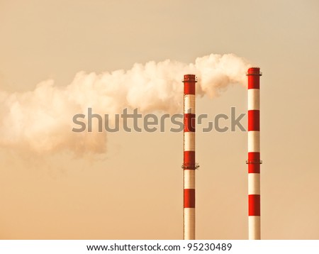 Lots of smoking chimneys pollution air , two chimney