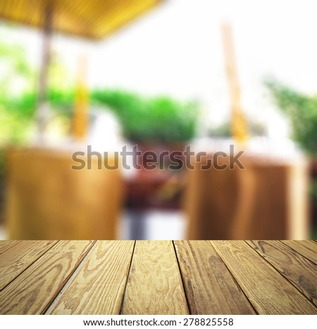 Empty wood table over blurred coffee shop with bokeh background, product display template,deck,