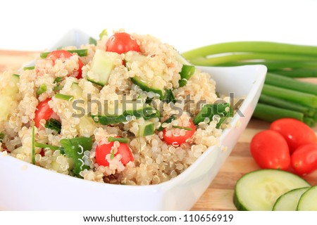 Cold quinoa salad with cucumbers, cherry tomatoes, green onions and herbs