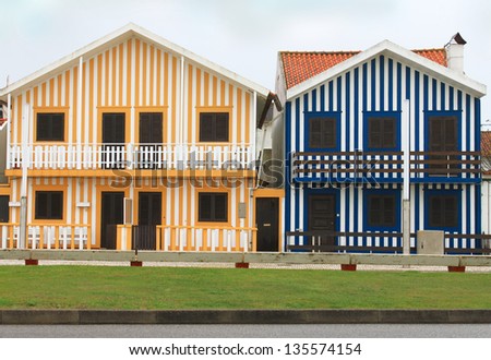 Costa Nova colorful striped fishermen\'s houses in blue and yellow of the Beiras, Portugal, Europe