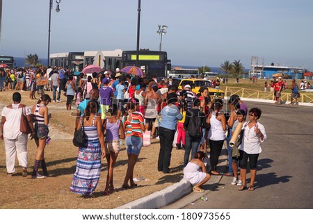 HAVANA,CUBA-FEBRUARY 22,2014: Crowds of people wait to board a transit bus in Havana Cuba, on February 22, 2014