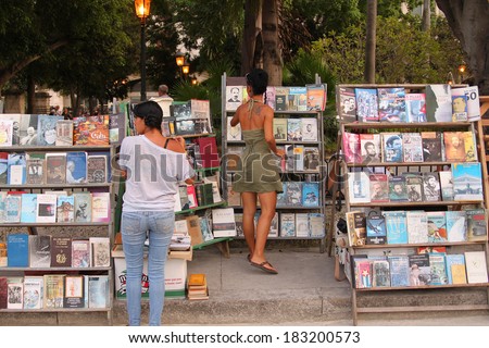 HAVANA, CUBA - FEBRUARY 22, 2014: People gathering for a book fair and sale along the famous wooden road in Havana, Cuba on February 22, 2014