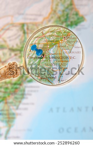 Blue tack on map of Eastern USA with magnifying glass looking in on Washington D.C.