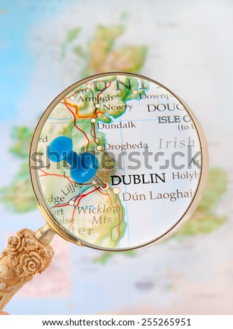 Blue tack on map  with magnifying glass looking in on Dublin, Ireland, United Kingdom