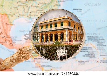 Looking in on architecture in Trinidad, Cuba with blurred Caribbean map in the background