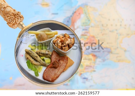 Looking in on food of the world showing tapas of Spain with a magnifying glass or loop with European map in the background