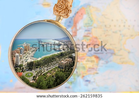 Looking in on Malaga Spain with a magnifying glass or loop with European map in the background