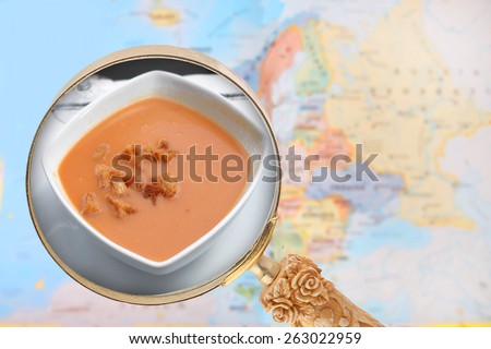 Looking in on foods of the world showing Gazpacho soup from Spain with European map in the background