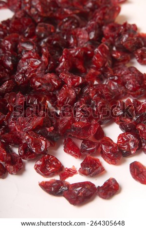 Pile of dried red cranberries on a white background