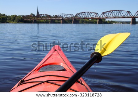 Kayaking on the Saint John River  in Fredericton, New Brunswick in Atlantic Canada with walking bridge and church in the distance. Shallow depth of field