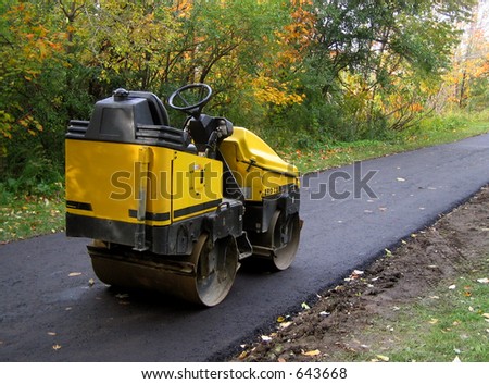 steam roller on freshly paved path