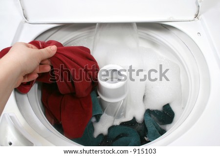 putting clothes into washer