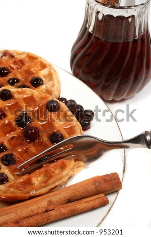 delicious waffles with blueberries and syrup