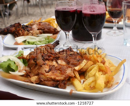 chicken,french fries and sangria at an outdoor restaurant