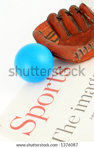 sports section of newspaper and ball with mitt