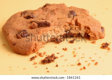 bite and crumbs of a  delicious chocolate chip cookie