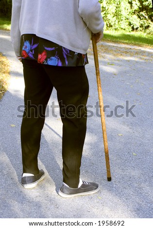 elderly woman with a cane to help with walking
