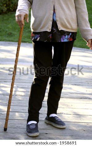 elderly woman with a cane to help with walking
