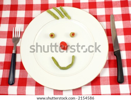 green beans and grape tomato in the shape of a happy face