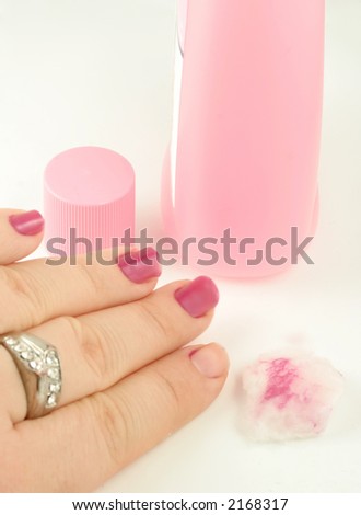 woman holds cotton ball with nail polish remover