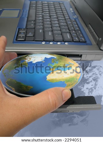 hand inserting the world into a computer