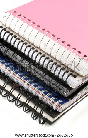 a pile of metal ring binder notebooks