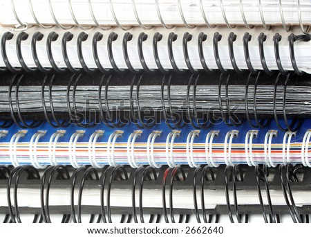 a pile of metal ring binder notebooks