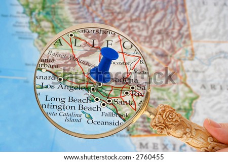 magnifying glass over Los Angeles, California map with destination tack