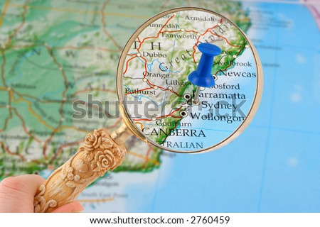magnifying glass over Sydney, Australia map with destination tack