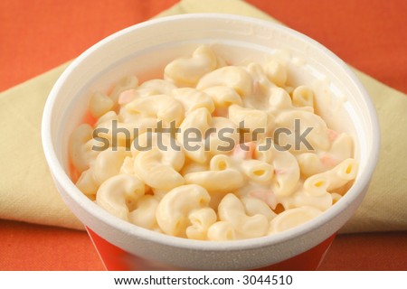 creamy macaroni salad in a styrofoam tub