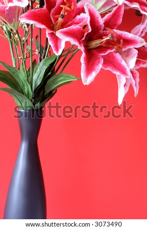 pink lily bunch in black vase with copy space