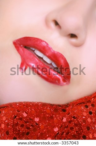 sexy red lips with dripping  lip gloss and chin resting on sequins