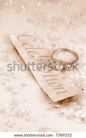 engagement ring on the word celebration surrounded by confetti