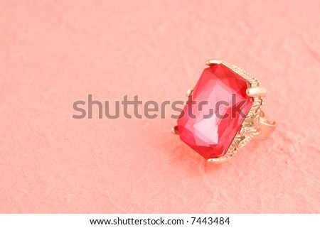 large pink stone engagement ring on pink background