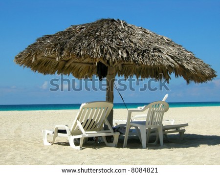Straw sun shelter and beach chairs at Varadero beach, Cuba