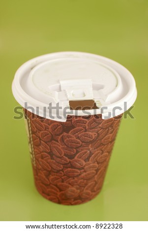 a cup of coffee to go on a green background