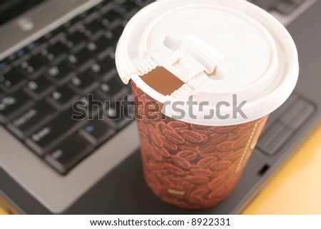 a cup of coffee to go on top of laptop