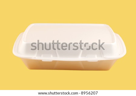 styrofoam take-out food container on a yellow background