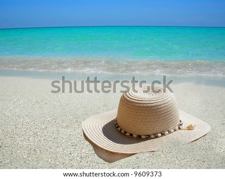 straw hat on the shore of a Caribbean beach