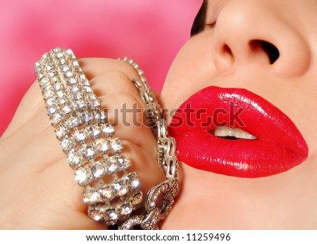 diamonds are a girl\'s best friend, woman with red glossy lipstick holding a diamond bracelet