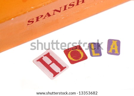spanish dictionary and learning spanish book with the word Hola on a white background