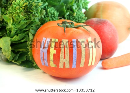 ripe fresh tomato with the word health and different vegetables in the background