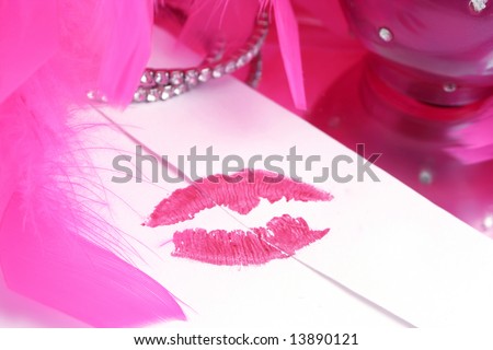 lipstick kiss on letter envelope surrounded byglamorous  pink feather boa  ( sealed with a kiss )