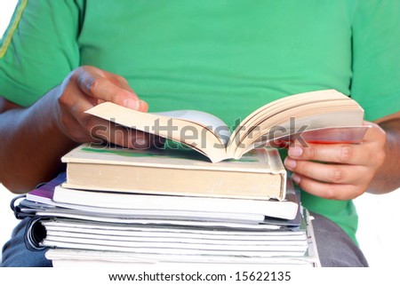 African American college male student with books on his lap reading