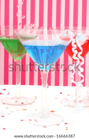 martini glasses with festive decorations like curled ribbons  with pink striped background