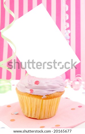 birthday cupcake with blank card or sign  in pink frosting with ribbon and confetti