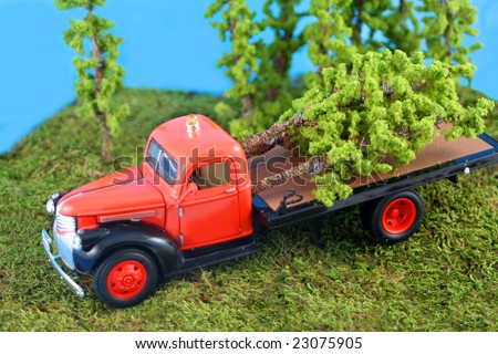 miniature truck with cut down trees in the back for the logging industry