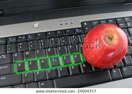 the word health glowing on a laptop computer keyboard and shiny red apple beside