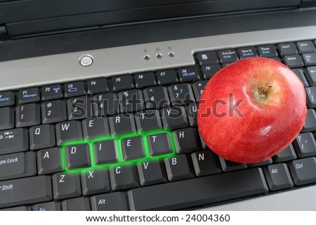 the word diet on  laptop computer keyboard glowing in green with apple beside it